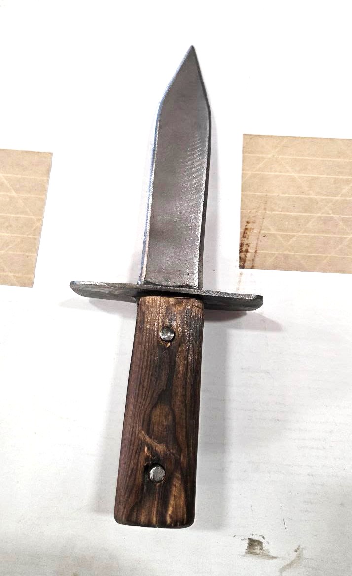 Hand-forged steel knife with a torched wood scale handle