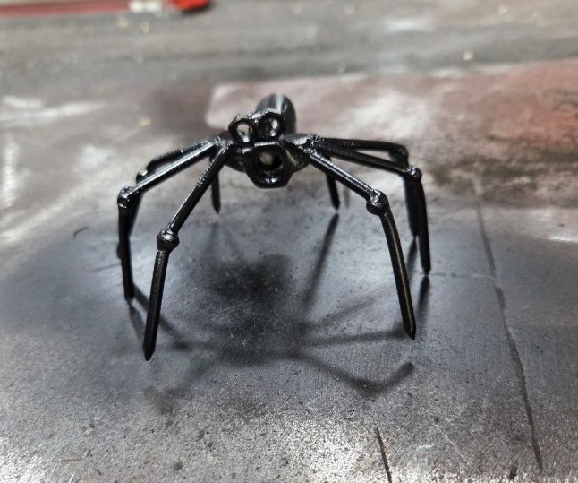 Finished black steel spider sculpture, a custom creative metalwork project