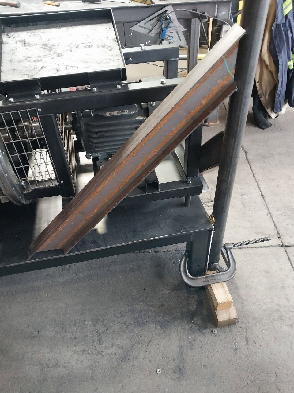 Steel angle iron section clamped and fitted during a custom fabrication build
