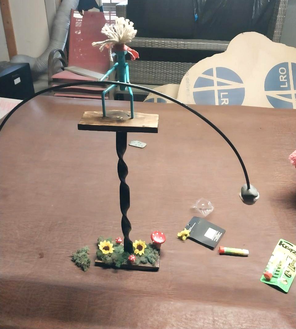 Finished twisted steel display stand with wood base and decorative garden scene