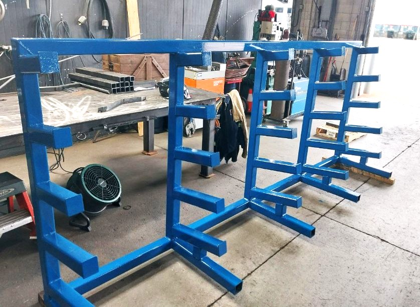 Custom fabricated blue steel material storage rack with cantilever arms