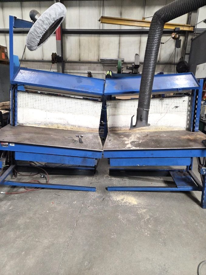 Pair of heavy steel welding workbenches with fume extraction and adjustable tool shelves