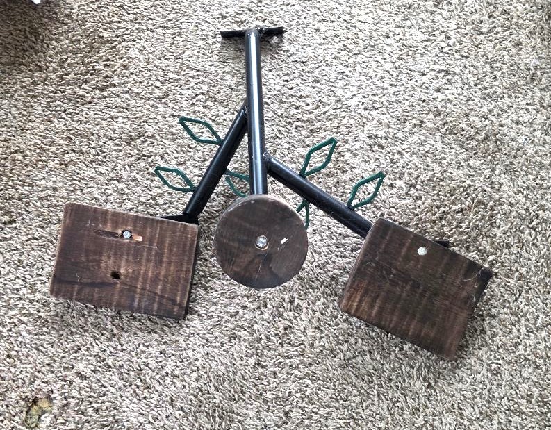 Steel plant stand base with forged leaf details and stained wood platforms