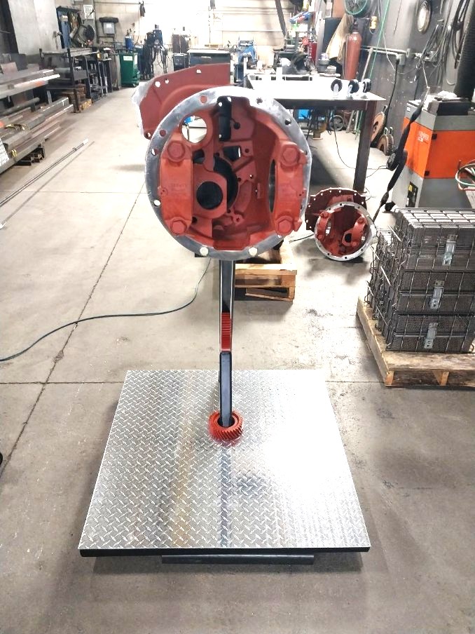 Diamond plate rolling stand fabricated for mounting and displaying a truck transmission housing