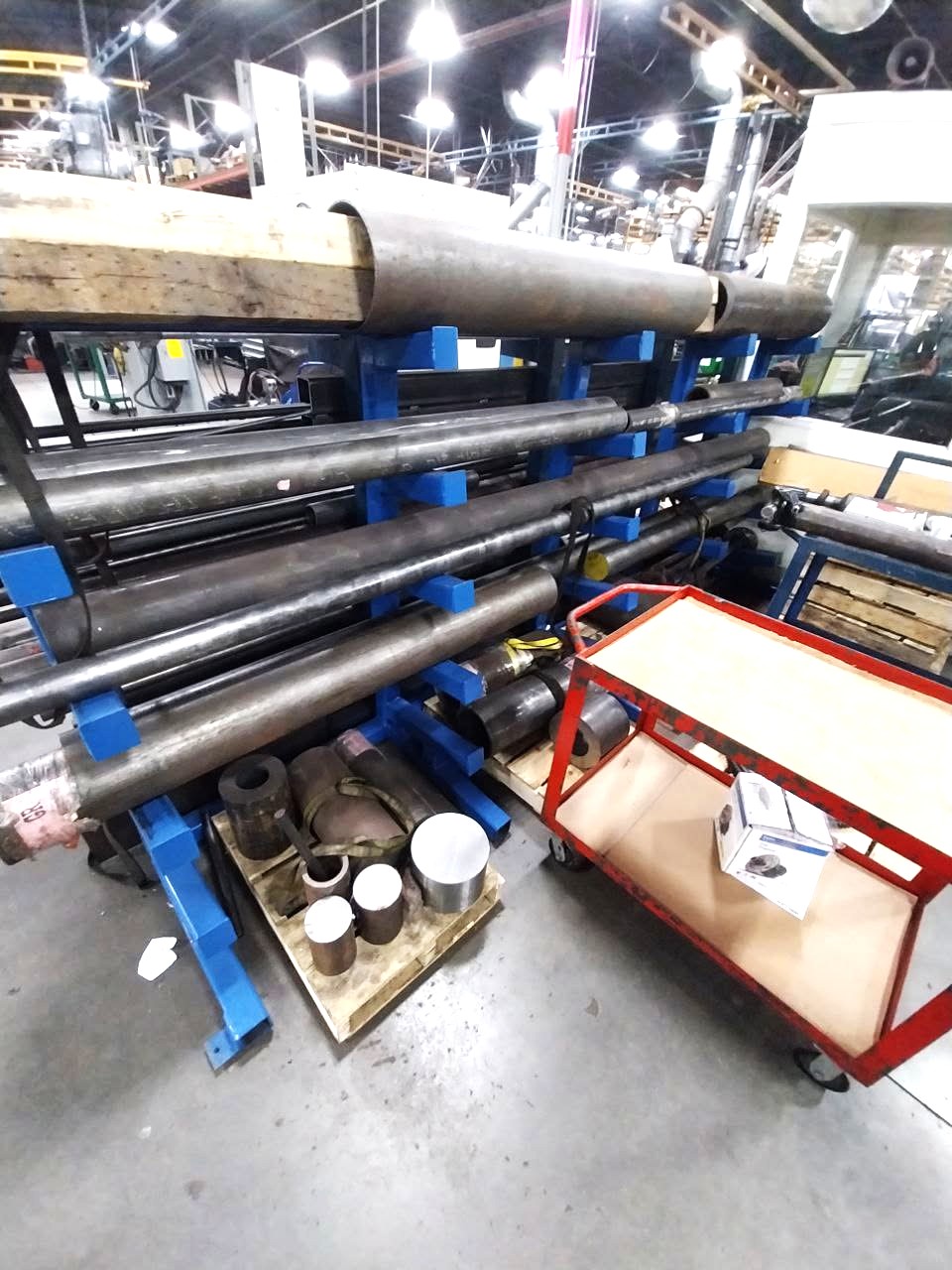 Blue cantilever steel rack fabricated for storing round tube and bar stock