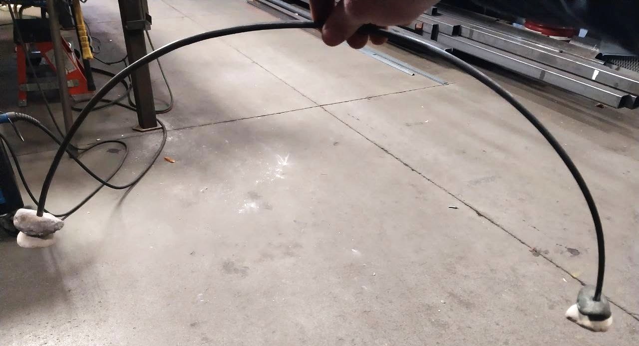 Steel rod bent into a smooth arch for a custom decorative stand