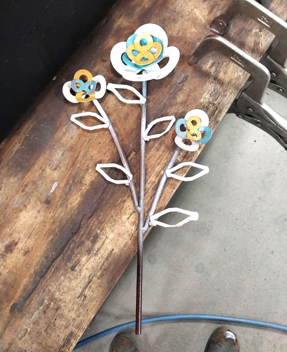 Hand-crafted metal flower sculpture made from washers and steel rod with painted accents