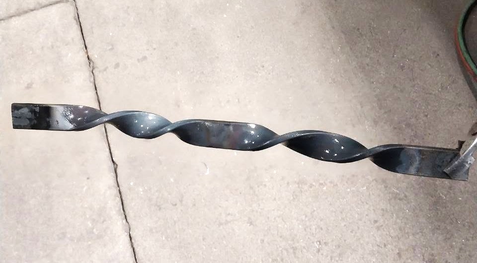 Finished hand-twisted steel bar ready for a custom decorative project