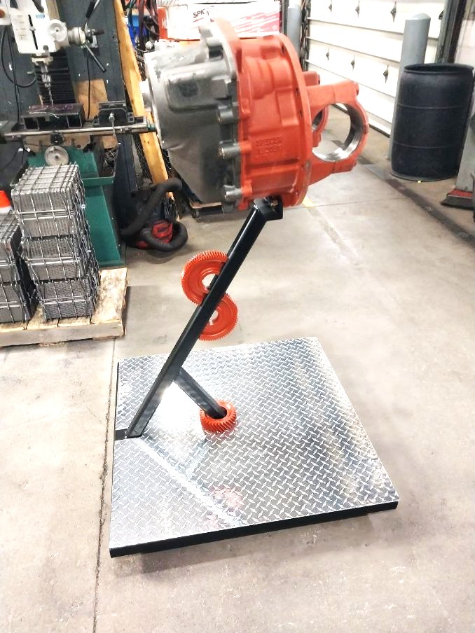 Angled steel post stand fabricated to display a rebuilt differential housing