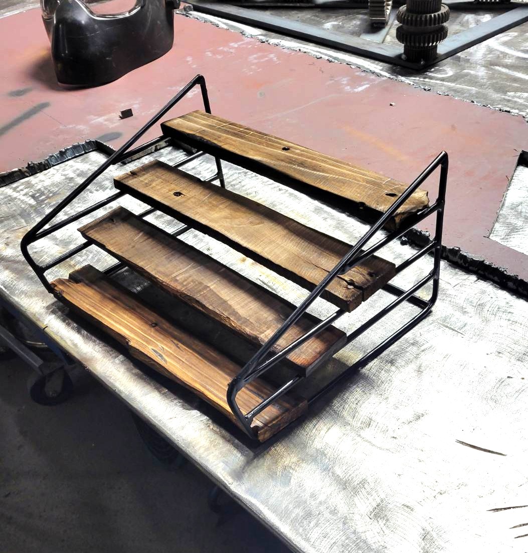Tiered steel and torched-wood display shelf fabricated in the shop