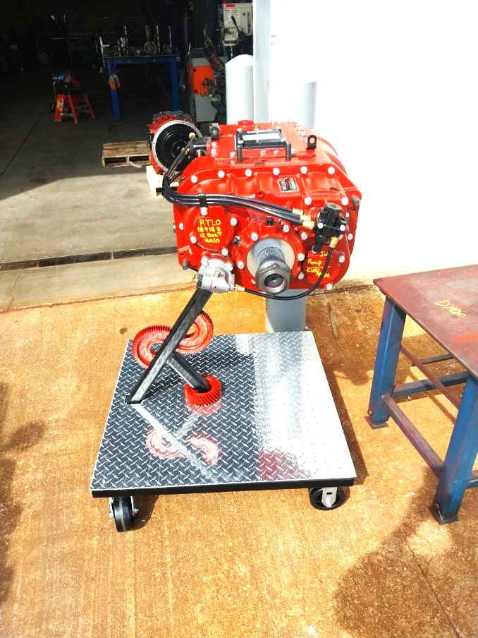 Rolling diamond plate transmission cart holding a rebuilt heavy truck transmission