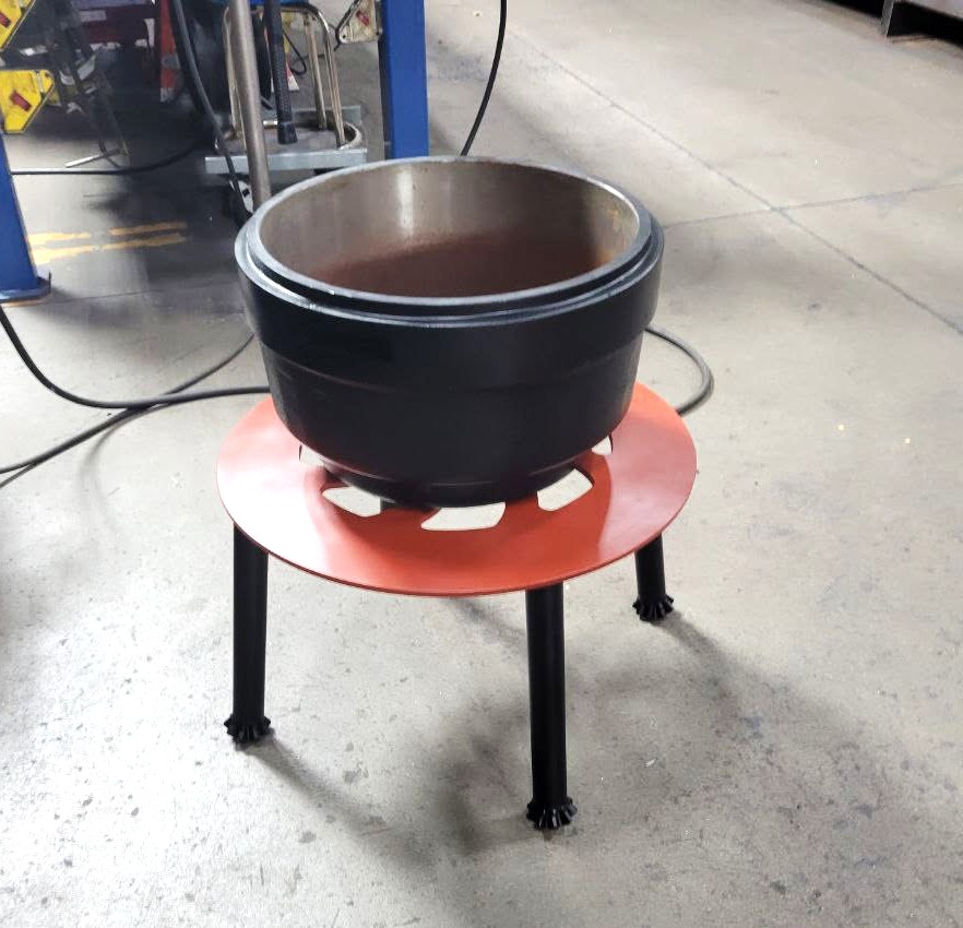 Custom steel fire pit bowl stand with cut-out top plate and decorative forged feet