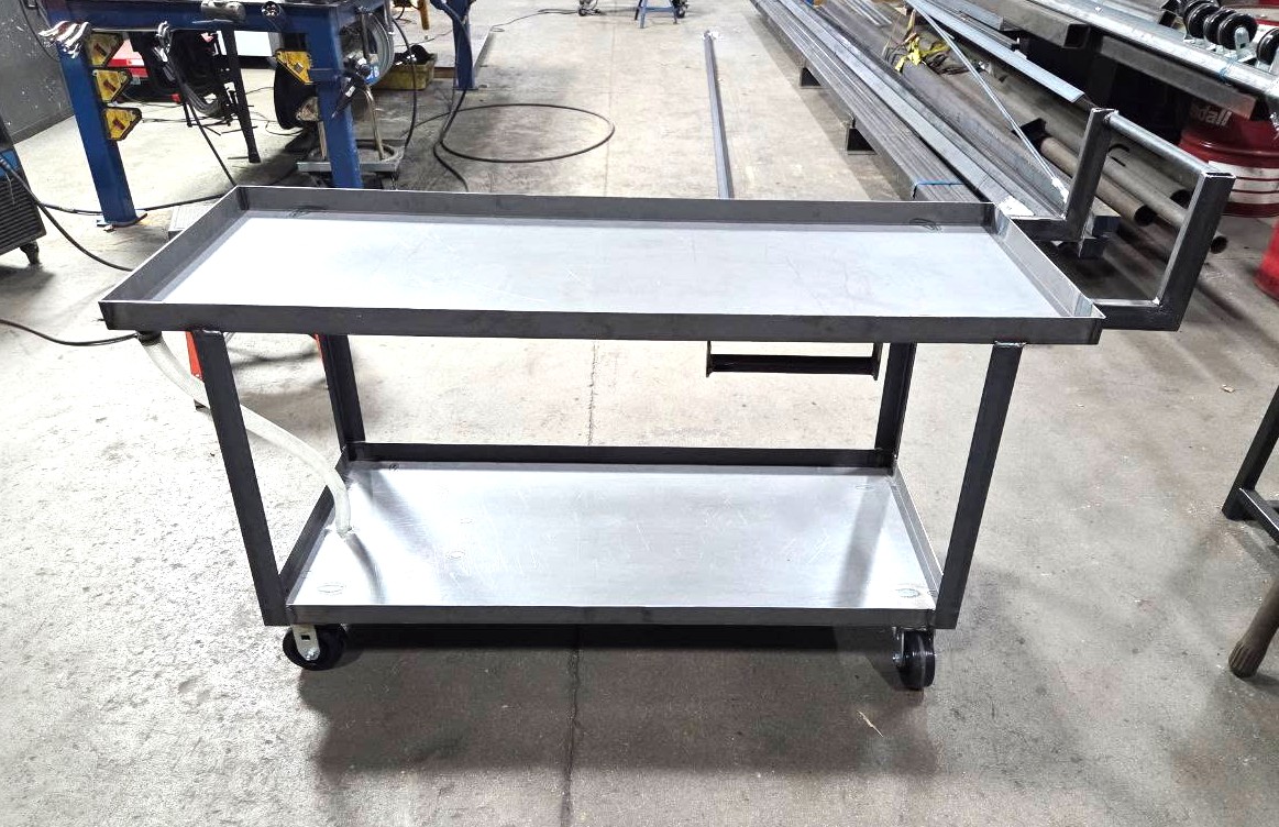 Two-tier steel shop cart with lipped trays, push handle, and heavy-duty casters