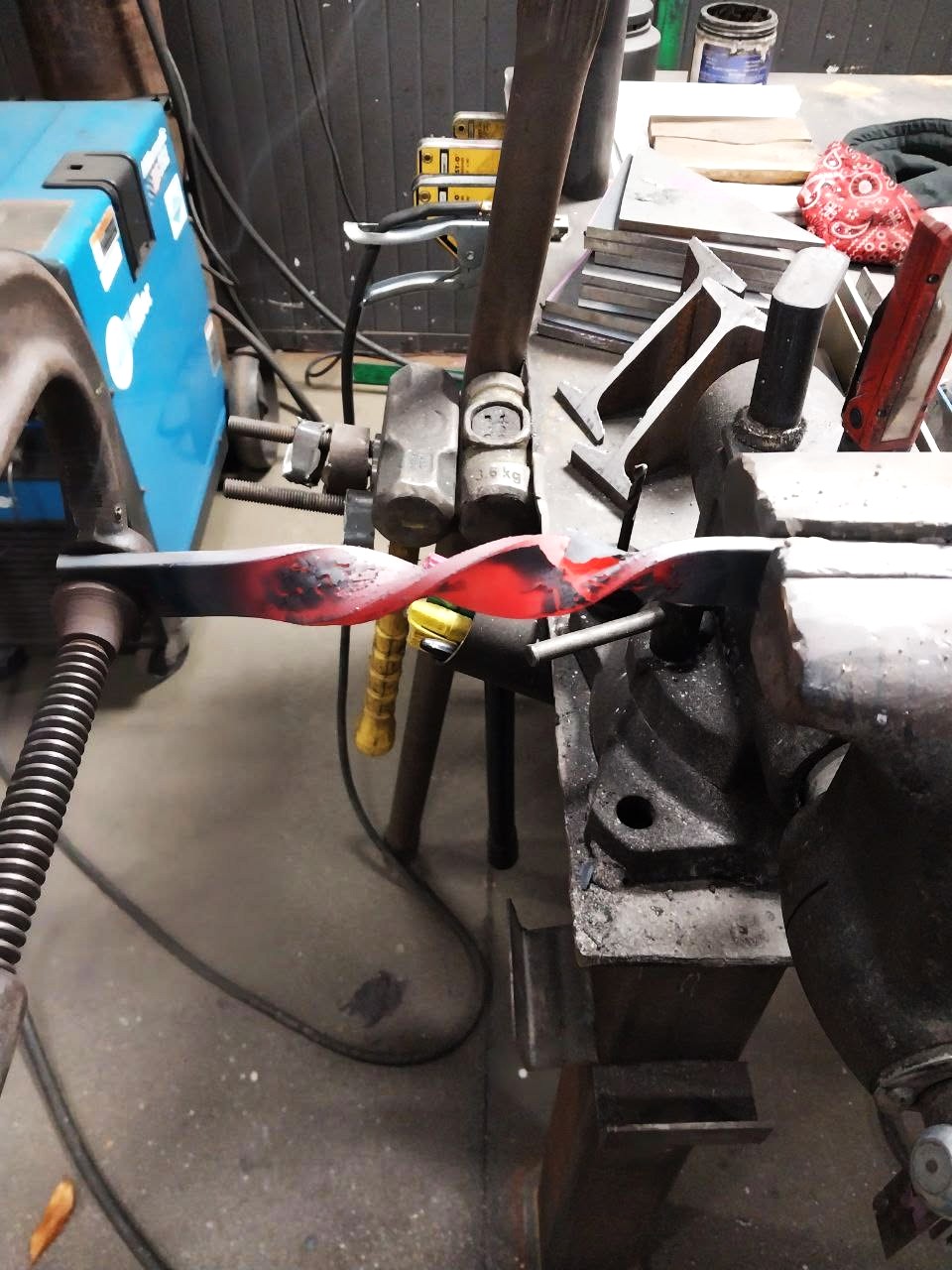 Heating and twisting flat steel bar in the vise to form a decorative element
