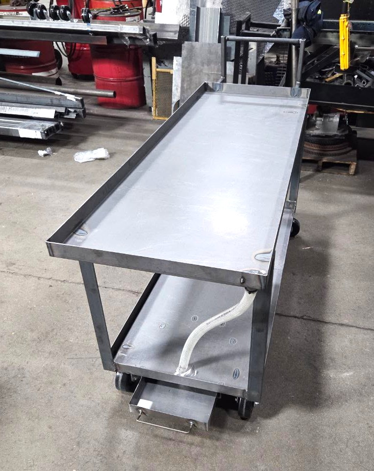Stainless steel rolling utility cart with lipped top tray, lower shelf, and pull-out drawer