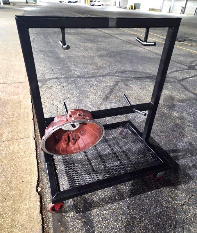 Fabricated black steel rolling parts cart with expanded metal deck and overhead hanging arms