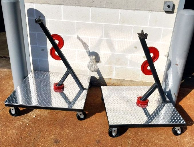 Matched pair of fabricated diamond plate transmission display carts with angled steel posts